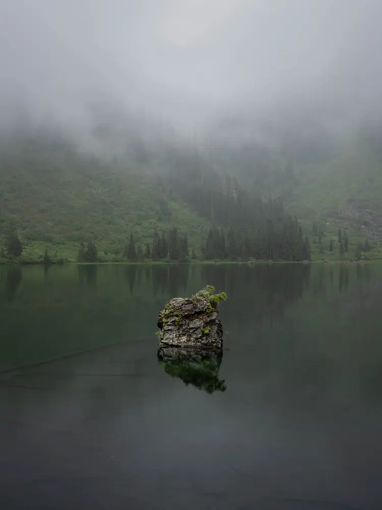A large boulder on the lake.